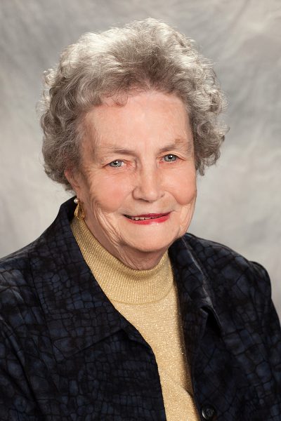 portrait photo of Margaret Rabida, a woman wearing a gold turtleneck underneath a black jacket