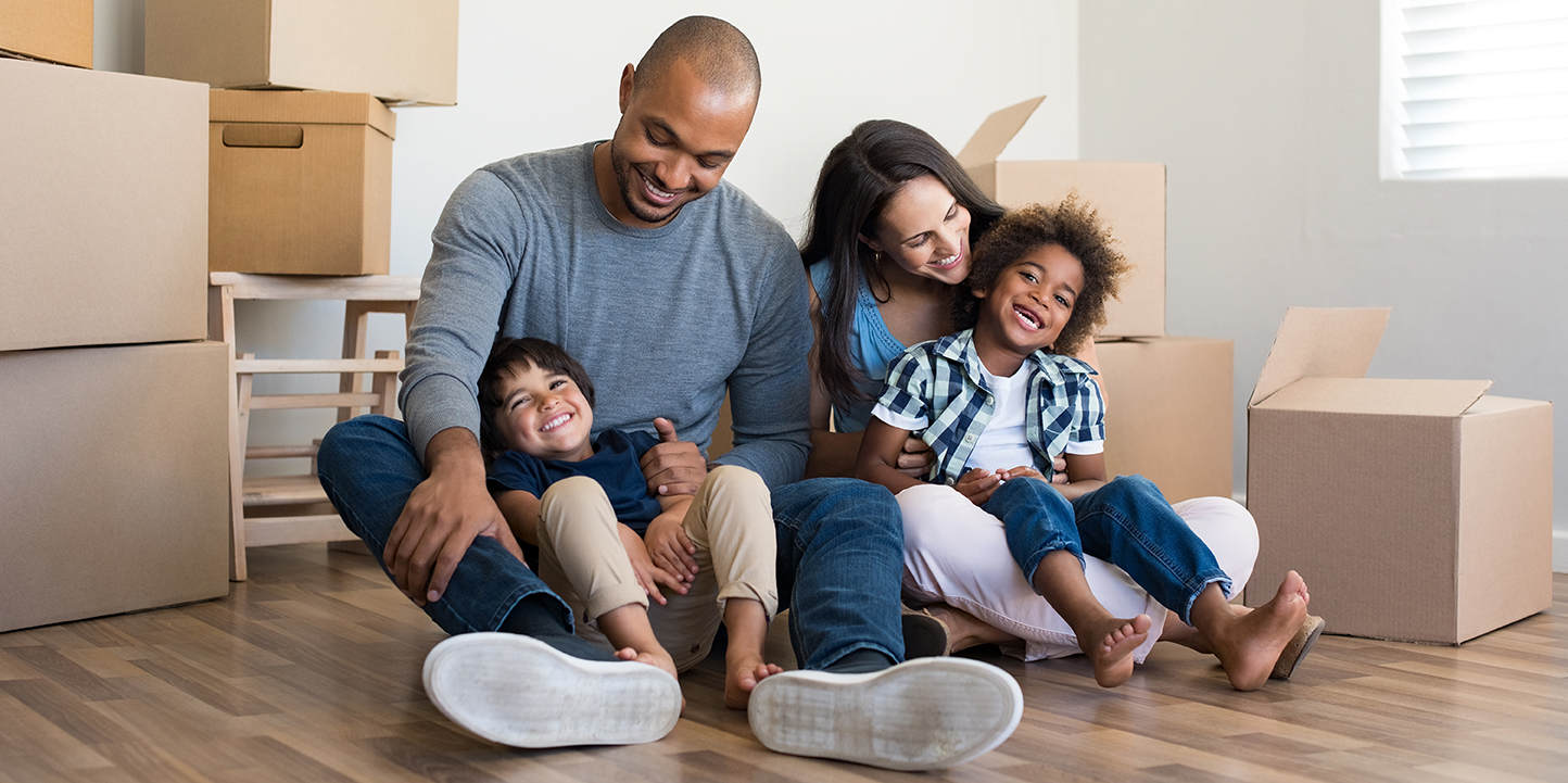 couple with two children with packed boxes considering a home equity loan for renovation or paying off debts