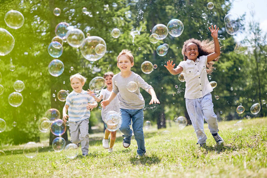 kids playing outside during the day at a youth center that received donations from HRCCU's Give4Kids Matching Campaign