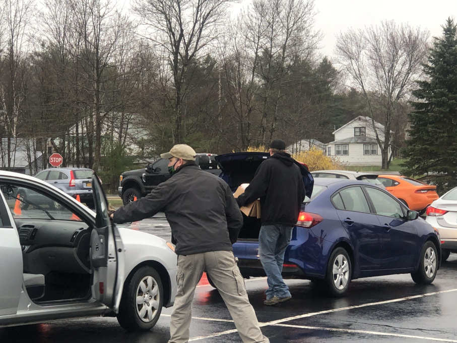 grocery totes being delivered to the trunks of cars by volunteers to provide food assistance to Northern Saratoga County