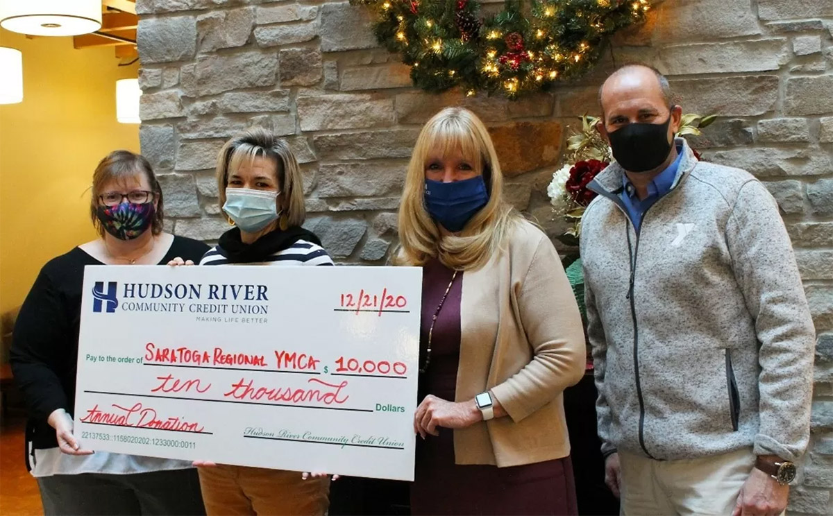 Saratoga Regional YMCA employees accepting $10,000 check from HRCCU CEO Sue Commanda to assist in their youth programs