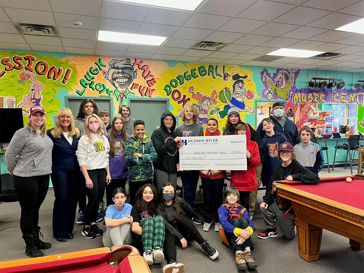 hrccu ceo presenting glens falls area youth center with donation check