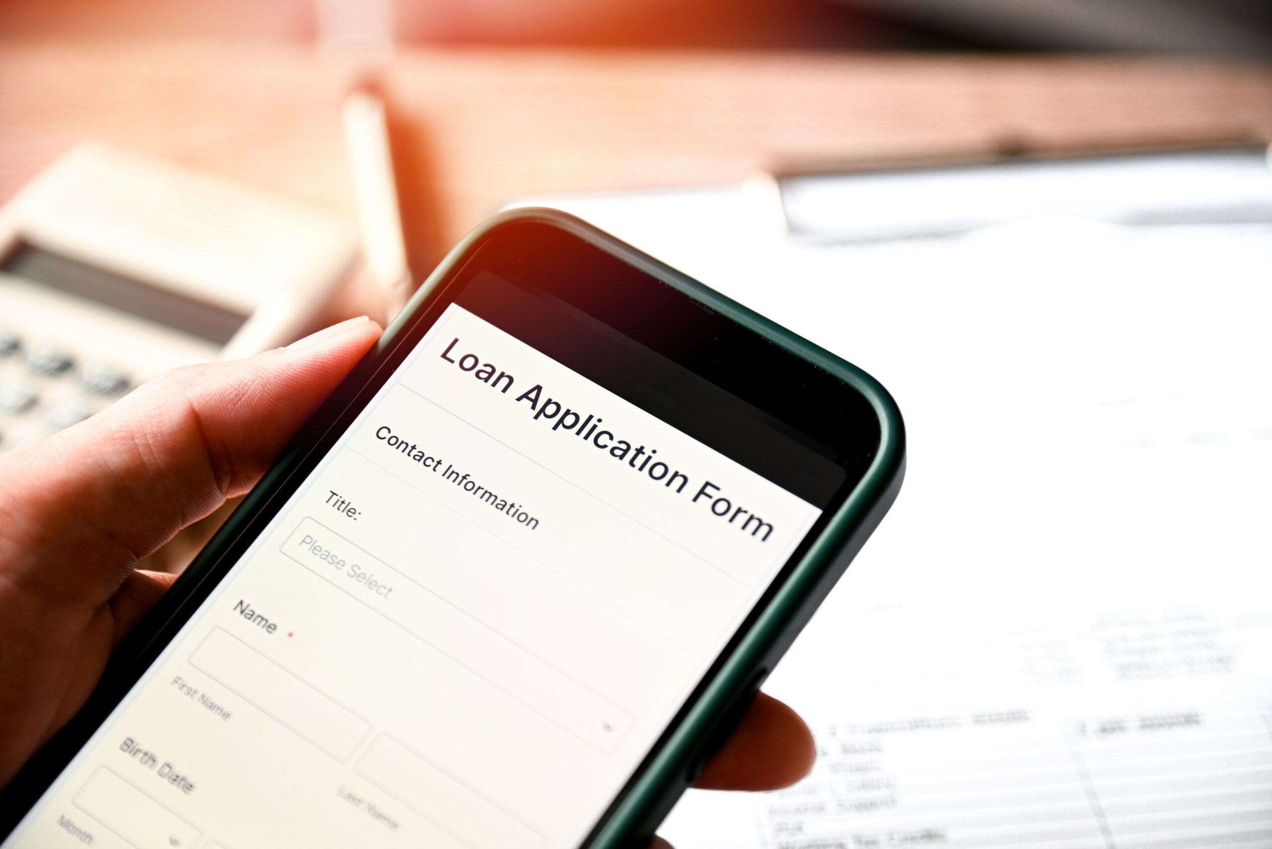 Loan Application Form on smartphone mobile application for Loan financial help form concept, Technology online, hand holding mobile smartphone with business via online personal loan apply.