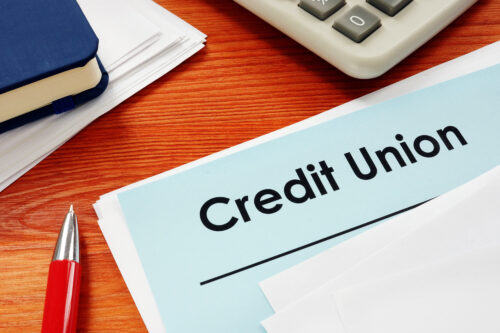 Credit Union papers for loan on desk.