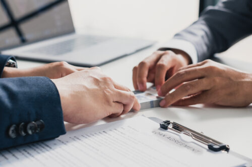 Closeup hands banker giving cash money to businessman, loan and credit financial lease concept