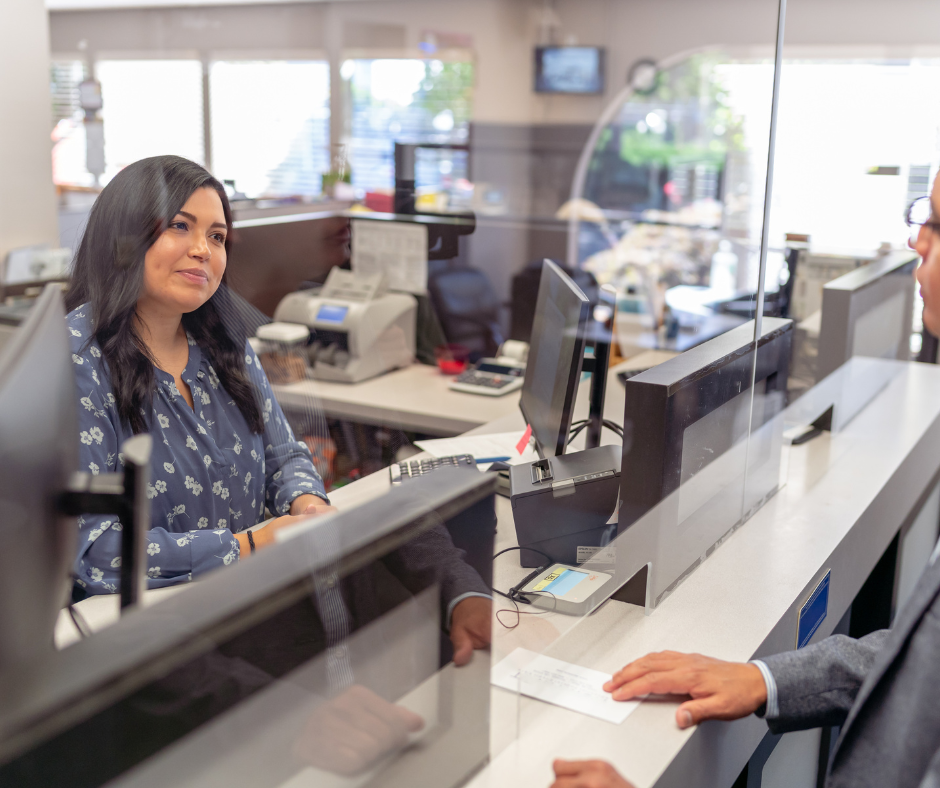 Cheerful bank teller assisting a customer