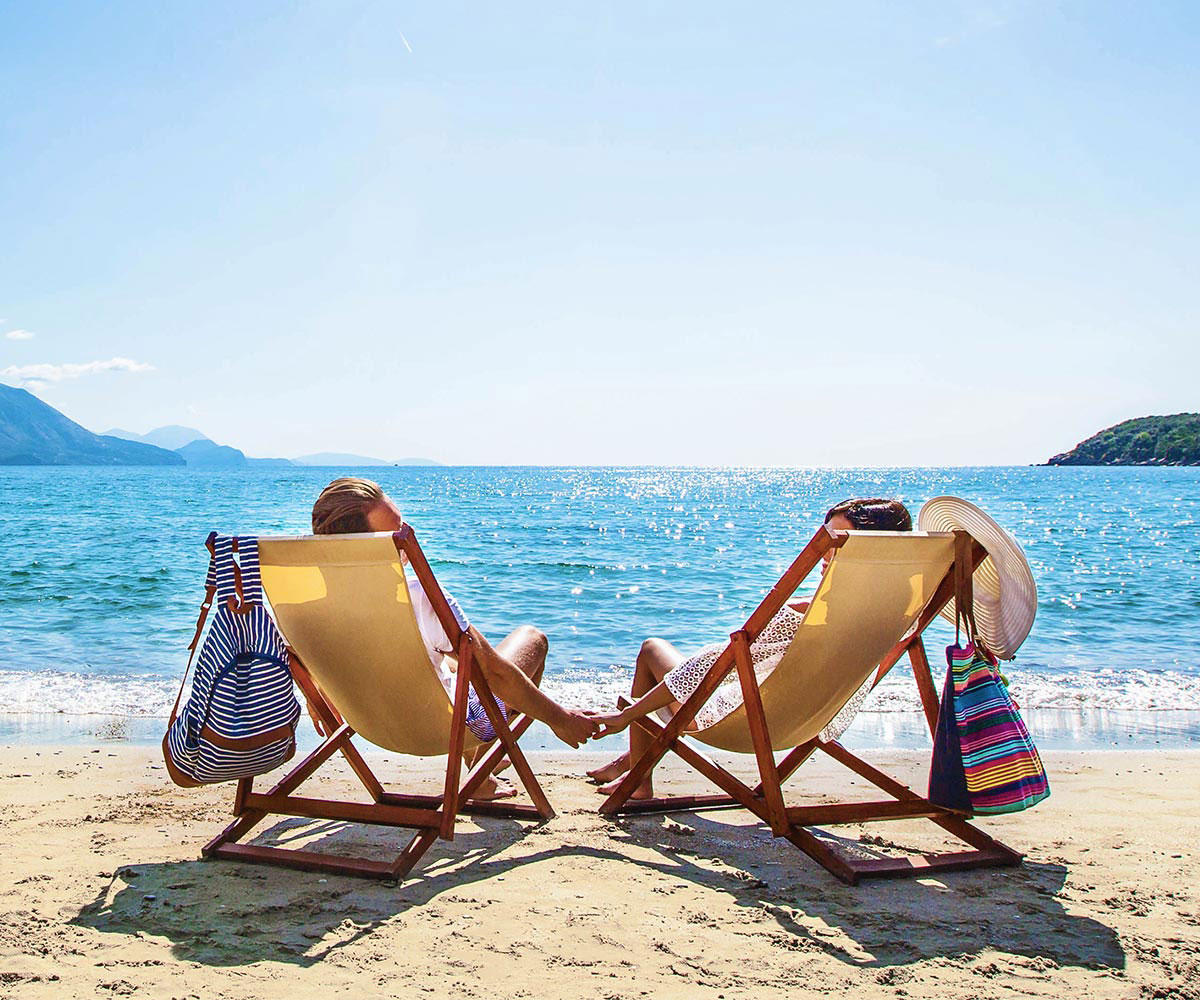 couple on beach looking over ocean