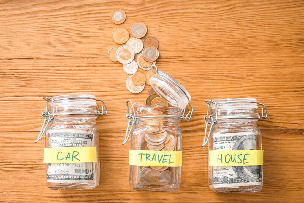 Jars with money represent how many people use sinking funds as a financial plan to save money for major life events.