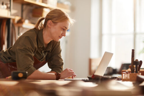 Business owner using online banking to forecast cash flow.
